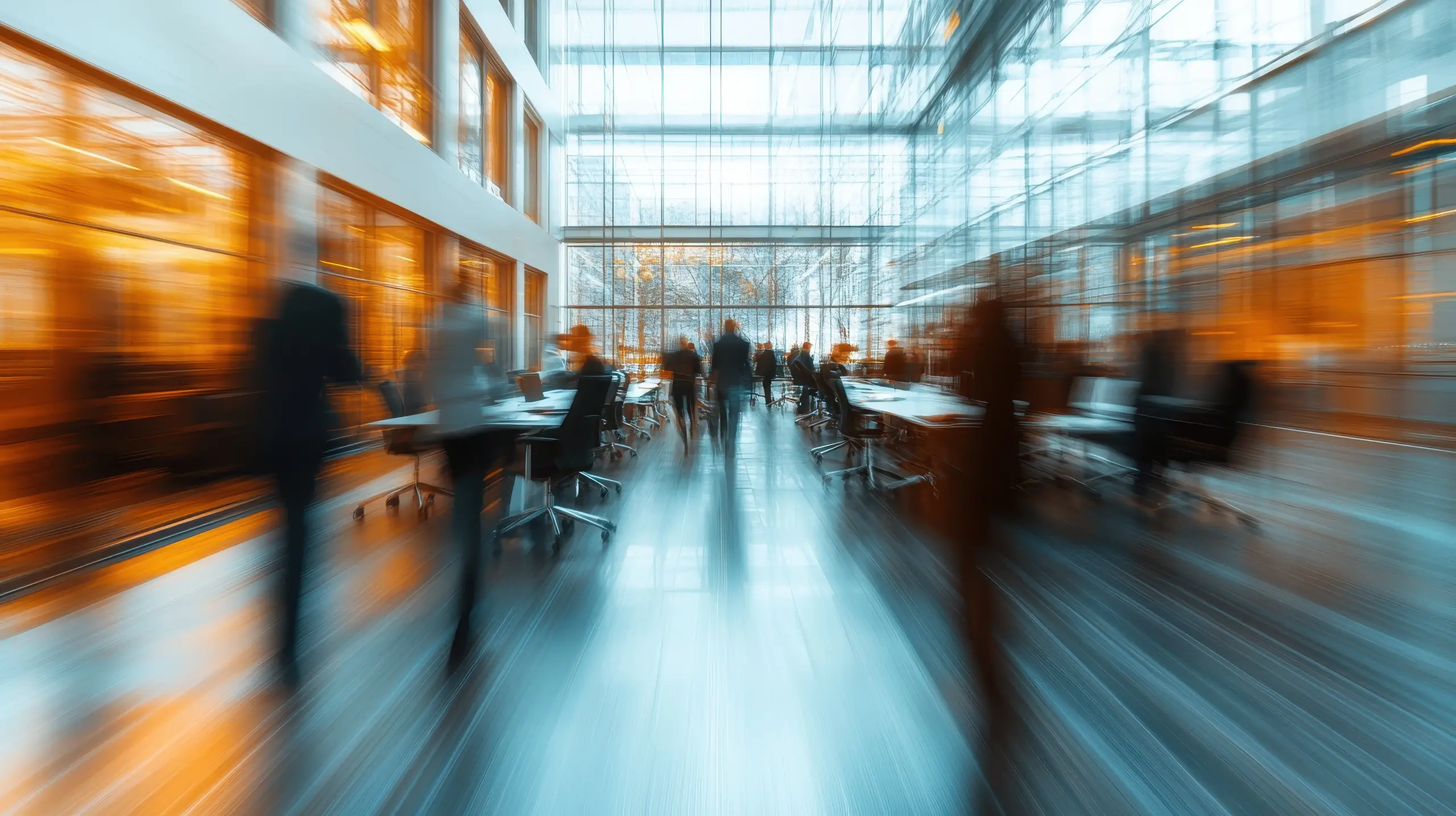 Modern Office Space with Blurred Motion of People Walking in a Bright, Glass-Walled Environment 